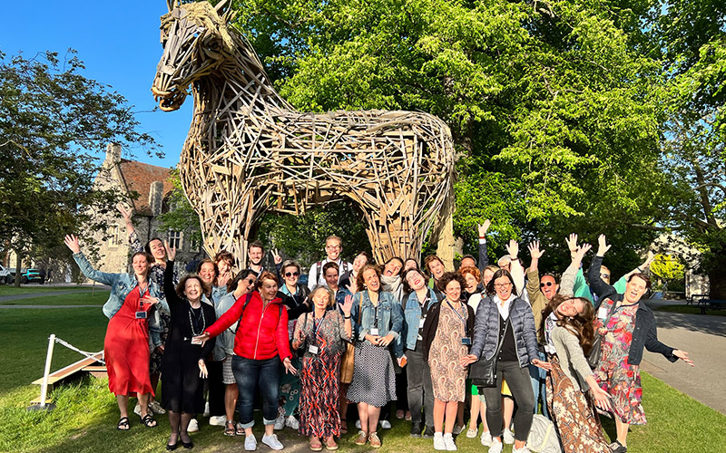 The group posing in front of the wooden horse in Canterbury Cathedral